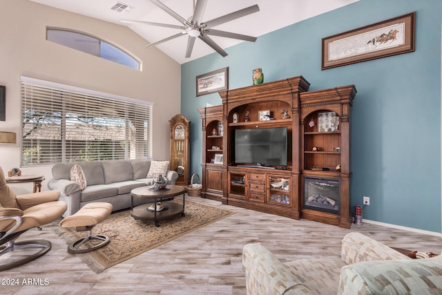 living room featuring vaulted ceiling, ceiling fan, and light hardwood / wood-style flooring