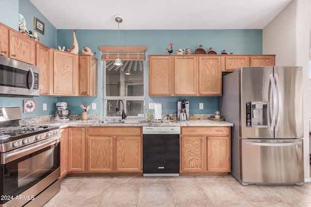 kitchen with sink, light stone countertops, appliances with stainless steel finishes, and decorative light fixtures