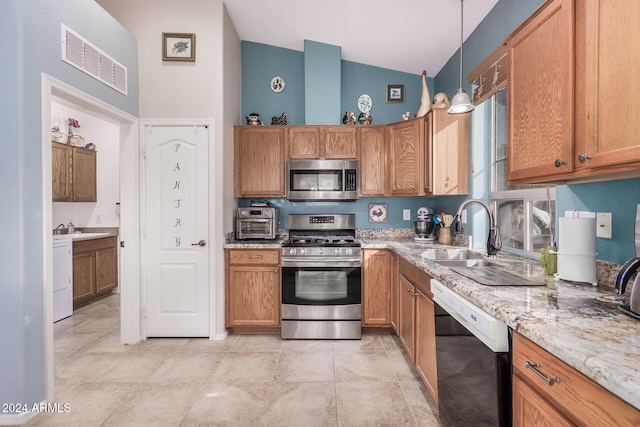 kitchen with hanging light fixtures, stainless steel appliances, lofted ceiling, and sink