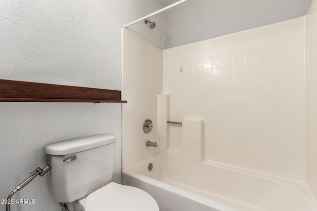 full bath featuring shower / bathtub combination, a textured wall, and toilet