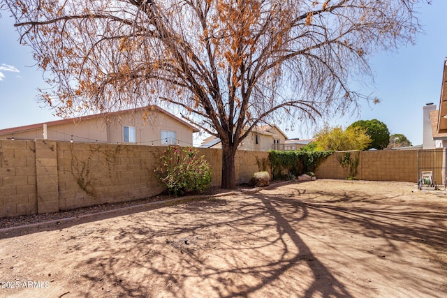 view of yard with a fenced backyard