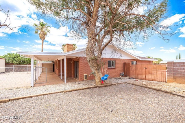 1315 Via Cabrillo, Sierra Vista, AZ 85635 - rear view of house featuring a chimney, brick siding, and a gate