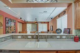 kitchen with dishwasher, sink, track lighting, and backsplash