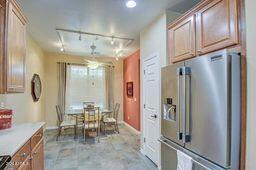 kitchen with track lighting and high quality fridge