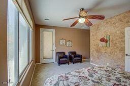 unfurnished bedroom featuring ceiling fan and light carpet