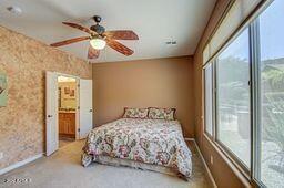 bedroom featuring connected bathroom, ceiling fan, and access to outside