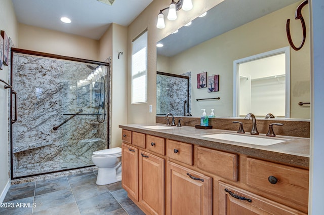 bathroom featuring vanity, toilet, and an enclosed shower