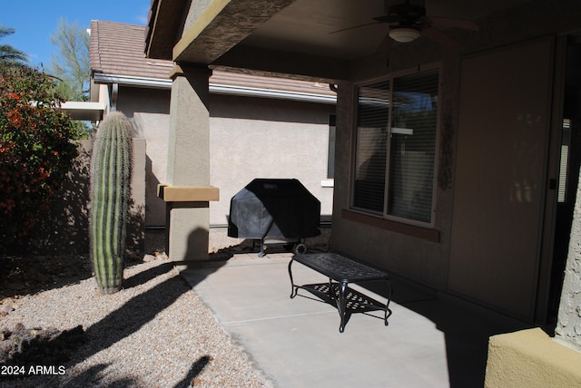 view of patio with area for grilling and ceiling fan