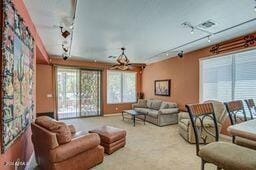 carpeted living room with rail lighting