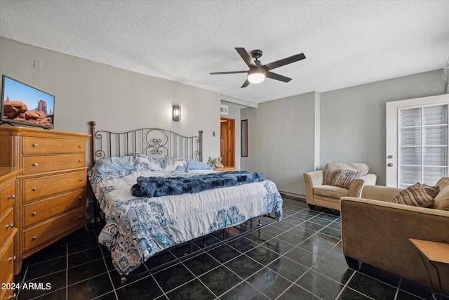 tiled bedroom featuring a textured ceiling and ceiling fan