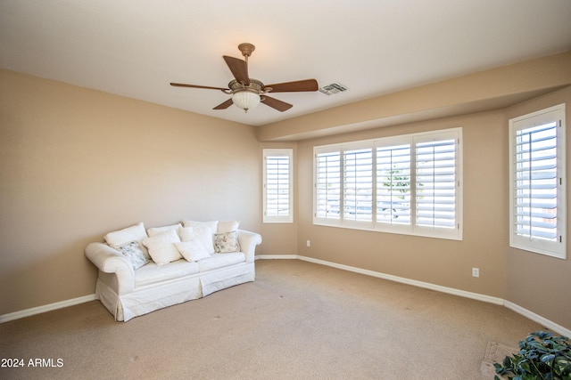 unfurnished room with a wealth of natural light, carpet floors, and ceiling fan