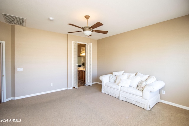 sitting room featuring ceiling fan and carpet floors