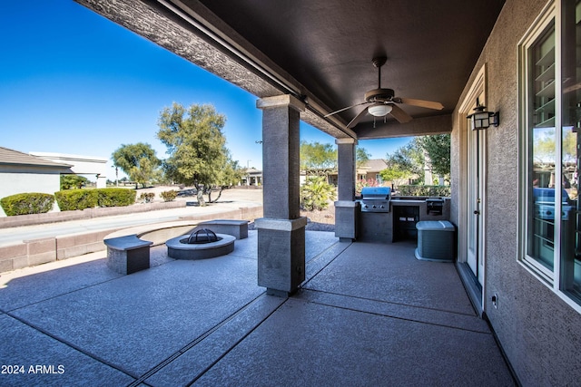 view of patio / terrace with area for grilling, ceiling fan, a grill, and a fire pit