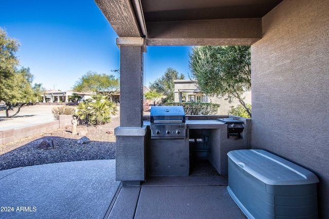 view of patio / terrace with an outdoor kitchen and a grill