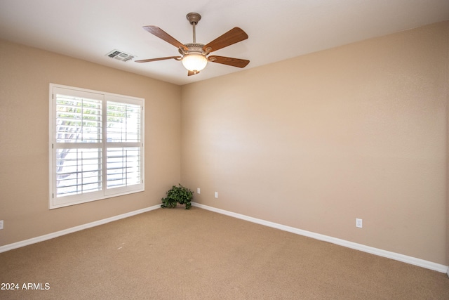 carpeted empty room featuring ceiling fan