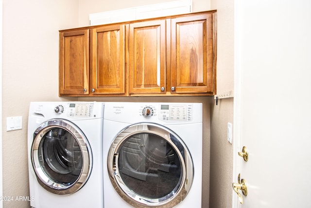 laundry area featuring cabinets and washing machine and dryer