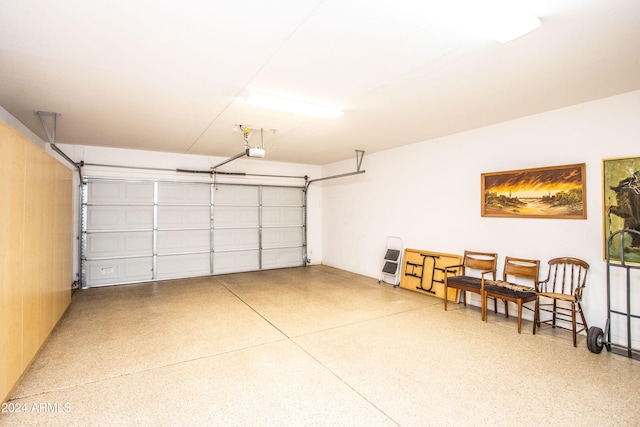 garage with wood walls and a garage door opener