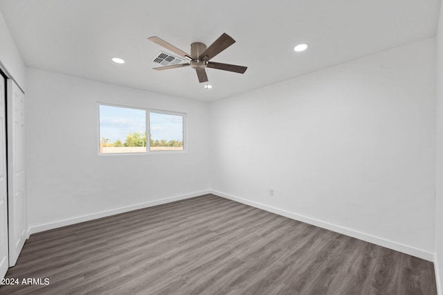 unfurnished bedroom featuring ceiling fan, a closet, and dark hardwood / wood-style floors