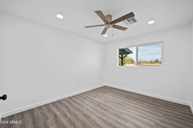 spare room with ceiling fan and dark wood-type flooring