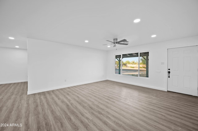 unfurnished living room featuring ceiling fan and light hardwood / wood-style flooring