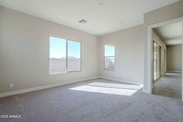 unfurnished room featuring light colored carpet