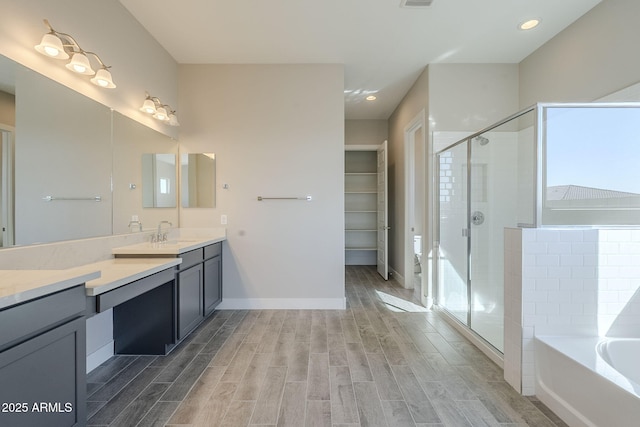 bathroom with vanity and independent shower and bath