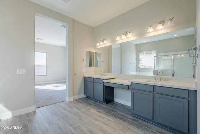 bathroom featuring vanity and a shower with shower door