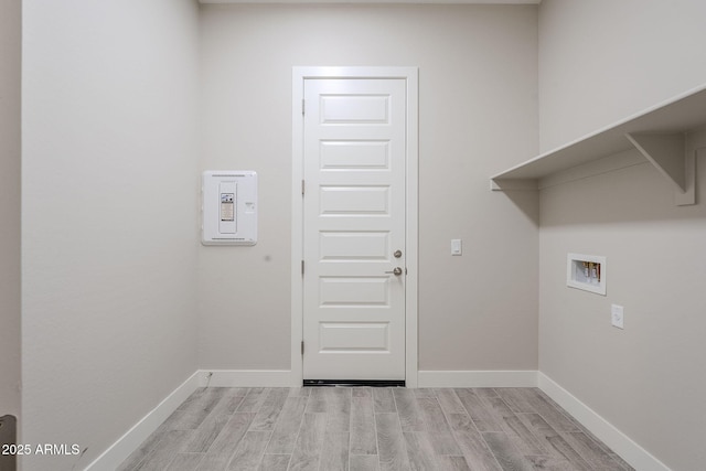 laundry room with hookup for a washing machine and light wood-type flooring