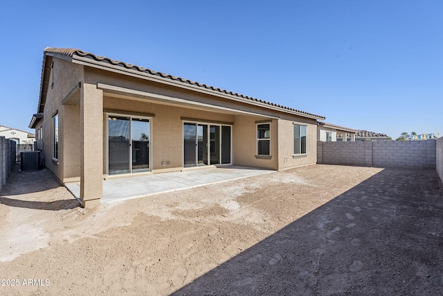 back of property featuring central AC unit and a patio area