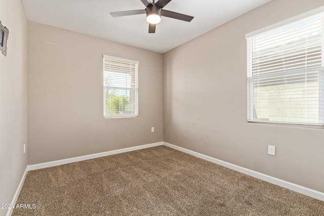 carpeted empty room featuring ceiling fan