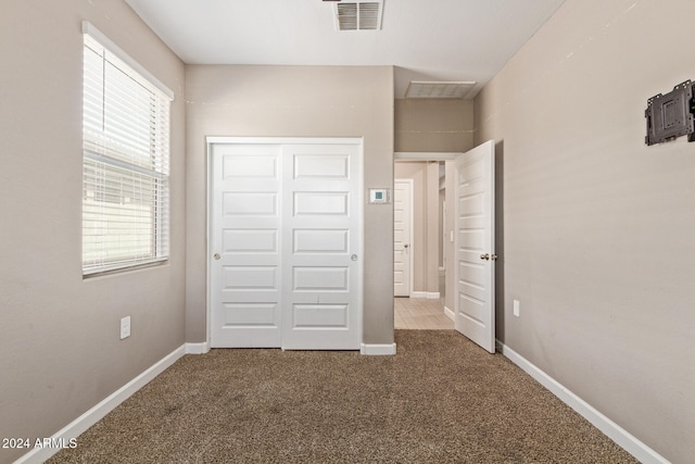 unfurnished bedroom featuring a closet and carpet