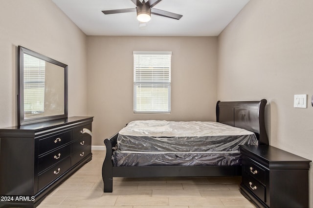 bedroom with light hardwood / wood-style floors and ceiling fan