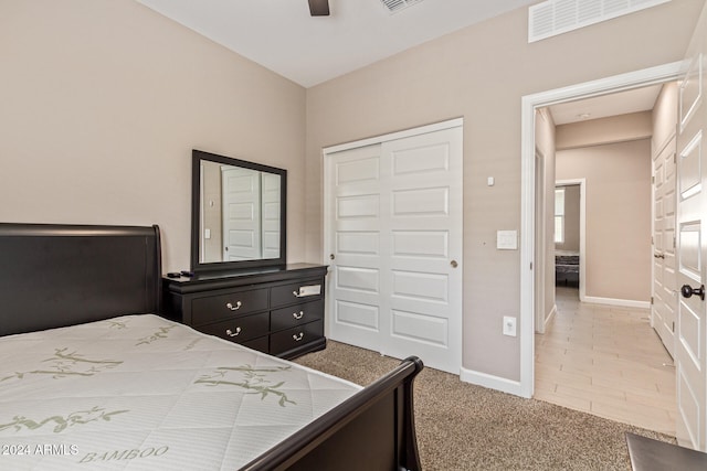 carpeted bedroom featuring a closet and ceiling fan