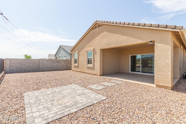 back of house with a patio