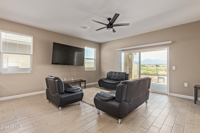 living room featuring plenty of natural light, light hardwood / wood-style floors, and ceiling fan