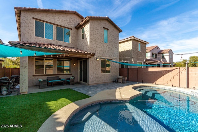 back of house with a fenced in pool and a patio area