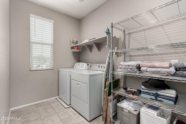 clothes washing area featuring separate washer and dryer and light tile patterned floors