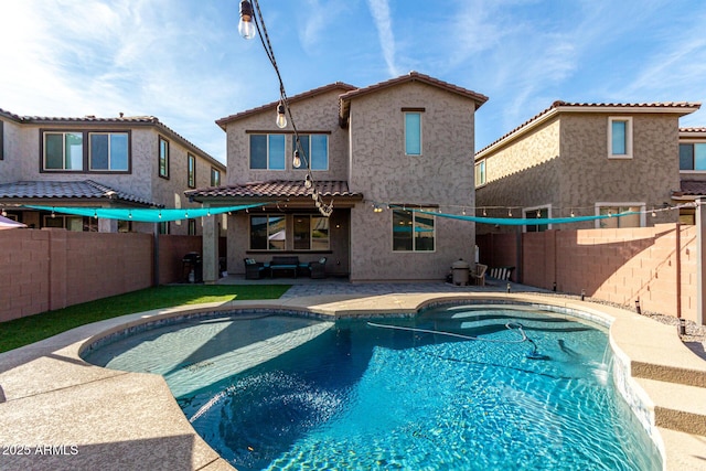 view of pool with pool water feature and a patio area