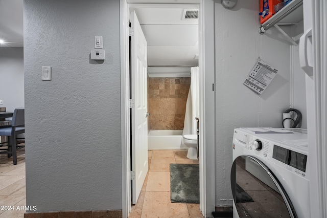 357 E Thomas Rd Unit A208, Phoenix, AZ 85012 - laundry room featuring washer / dryer and a textured wall