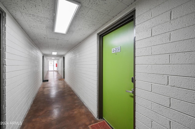 357 E Thomas Rd Unit A208, Phoenix, AZ 85012 - hallway featuring concrete floors and a paneled ceiling