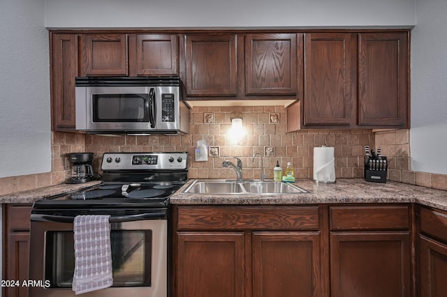 357 E Thomas Rd Unit A208, Phoenix, AZ 85012 - kitchen with stainless steel appliances, decorative backsplash, and dark brown cabinets