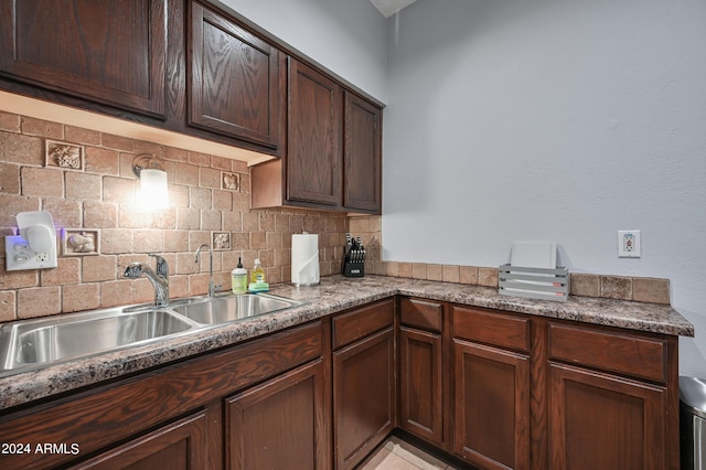 357 E Thomas Rd Unit A208, Phoenix, AZ 85012 - kitchen with tasteful backsplash and dark brown cabinetry