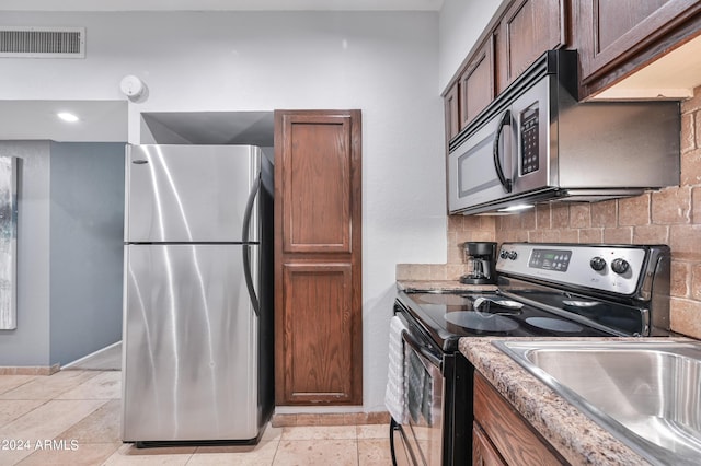 357 E Thomas Rd Unit A208, Phoenix, AZ 85012 - kitchen featuring appliances with stainless steel finishes and decorative backsplash