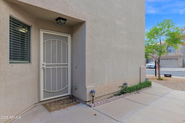 entrance to property with stucco siding