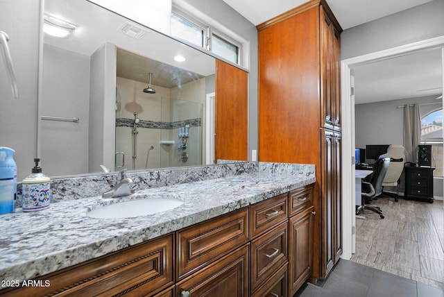 full bath with vanity, a stall shower, and visible vents