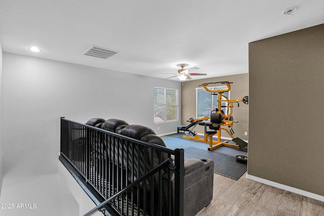 interior space with visible vents, baseboards, ceiling fan, and wood finished floors