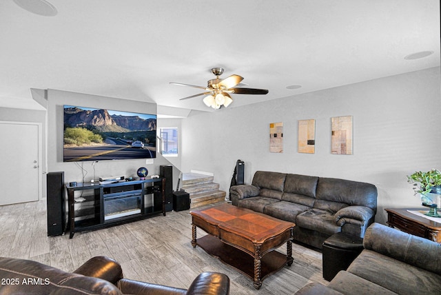 living room with a ceiling fan and wood finished floors