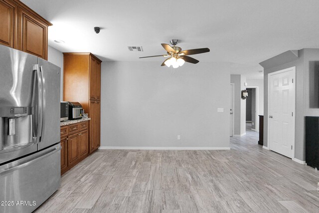 kitchen featuring brown cabinets, ceiling fan, light wood-type flooring, stainless steel refrigerator with ice dispenser, and visible vents