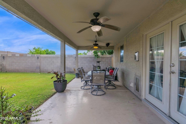view of patio featuring outdoor dining area, a ceiling fan, fence, and french doors