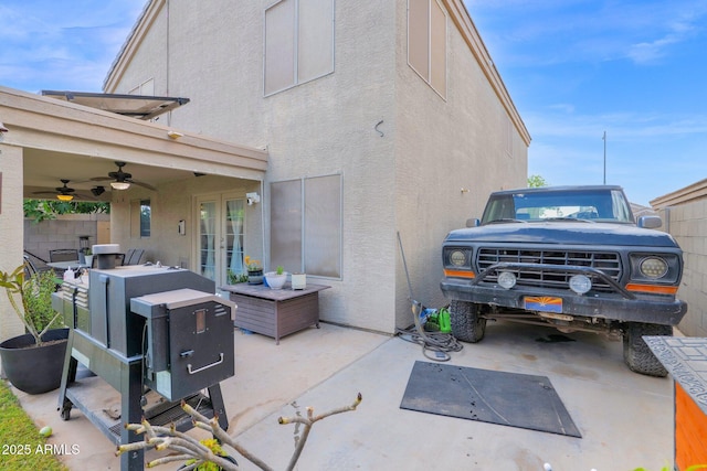 exterior space with a ceiling fan, french doors, a patio area, and stucco siding